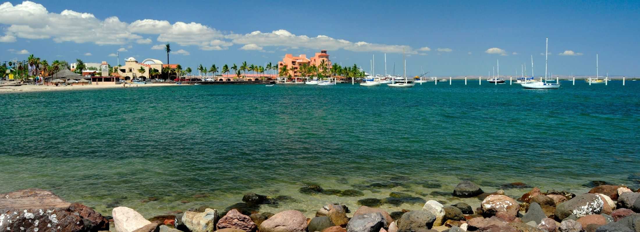 Beach front in La Paz with luxury houses and sailboats