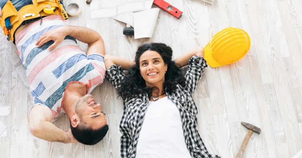 A happy couple smiling after working on home improvements