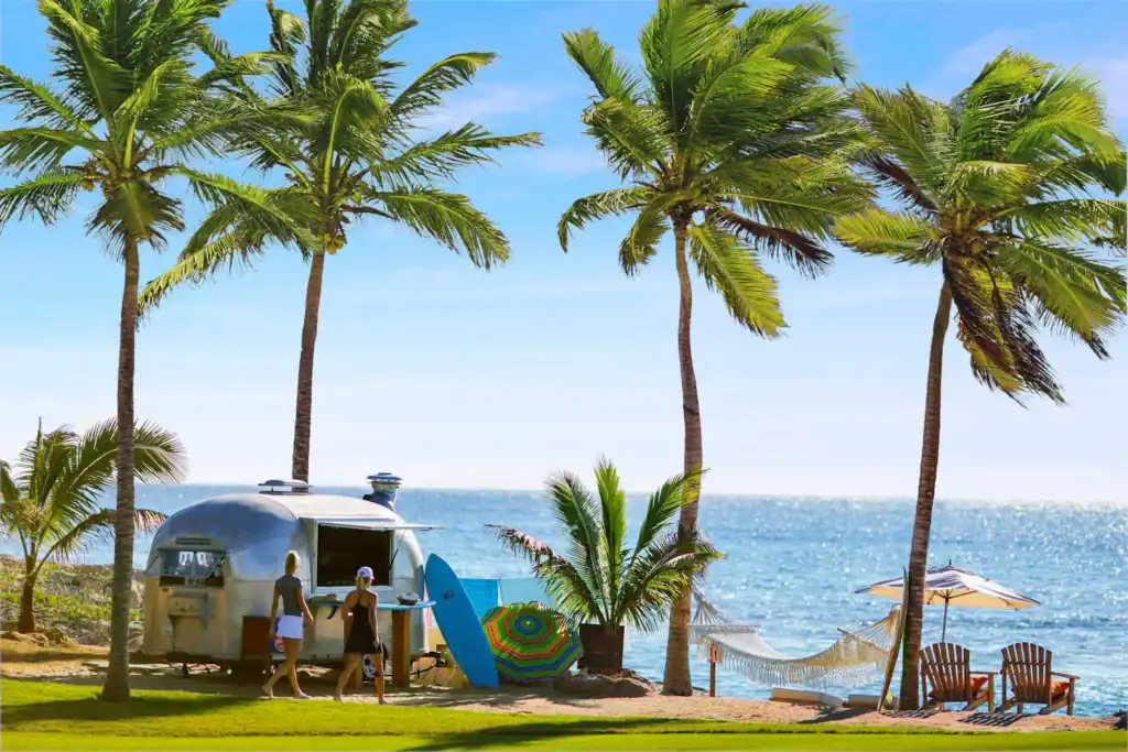 Beachfront amenities at Cabo del Sol with palm trees, hammock, and oceanside food service on the Sea of Cortez