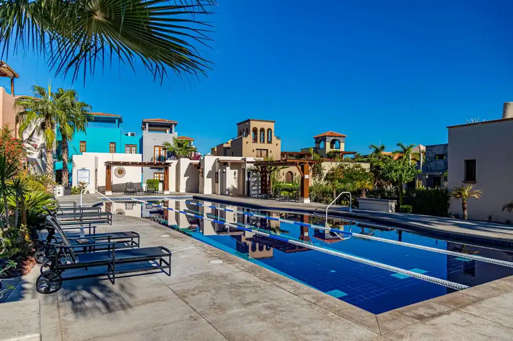 Community pool and colonial-style residential buildings with colorful facades at Loreto Bay, Nopoló, Baja California Sur, Mexico.