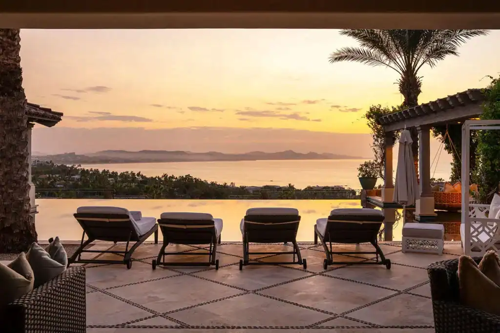 Infinity pool terrace with sunset views over the Sea of Cortez and Los Cabos coastline from a luxury villa in the San José Corridor, Baja California Sur, Mexico.
