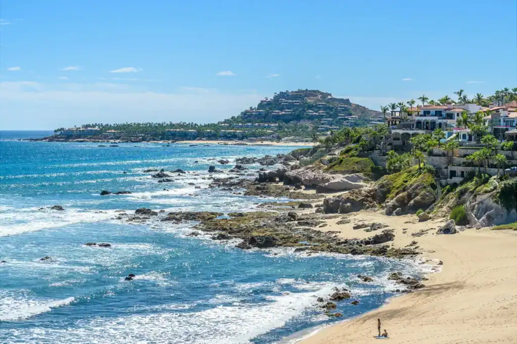 Luxury oceanfront villas and estates along the Los Cabos Corridor coastline with hillside residential development in the background, San José del Cabo, Baja California Sur, Mexico.