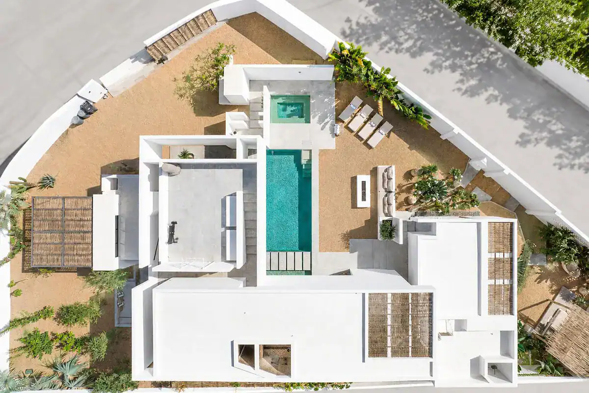 Aerial view of a new white modern home with a pool and terraces, illustrating new construction or resale in Los Cabos